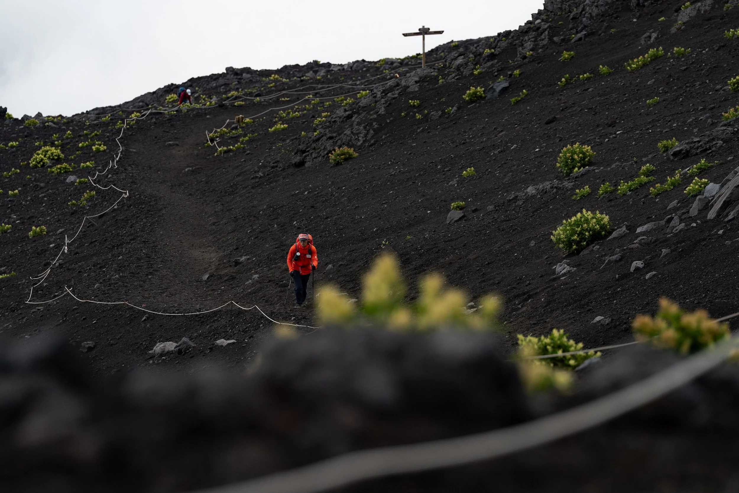 Hiker crossing the volcanic slope of Mt. Fuji